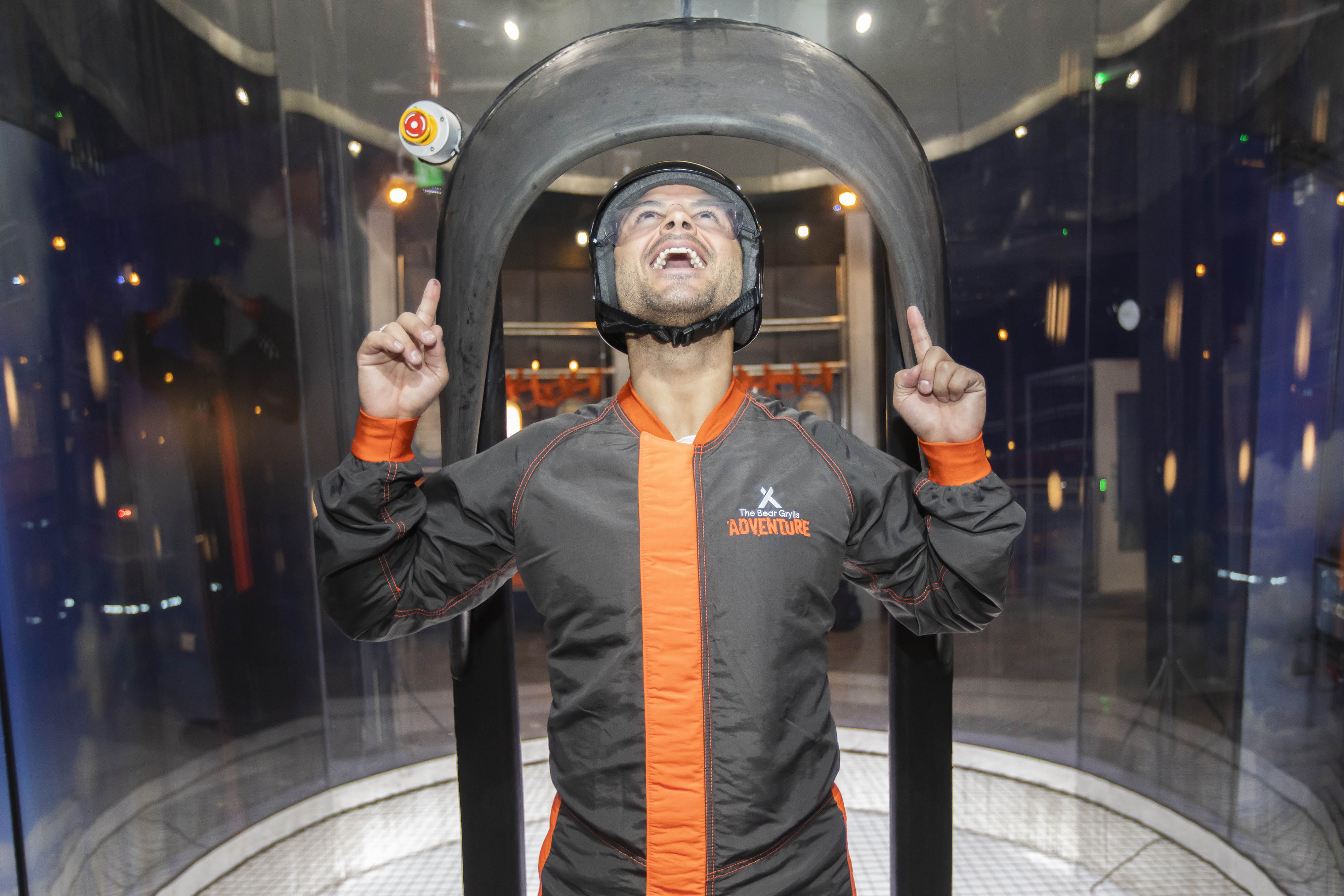 Man points fingers in front of iFLY tunnel at The Bear Grylls Adventure Birmingham