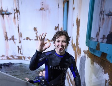 Young man exits dive tank at The Bear Grylls Adventure